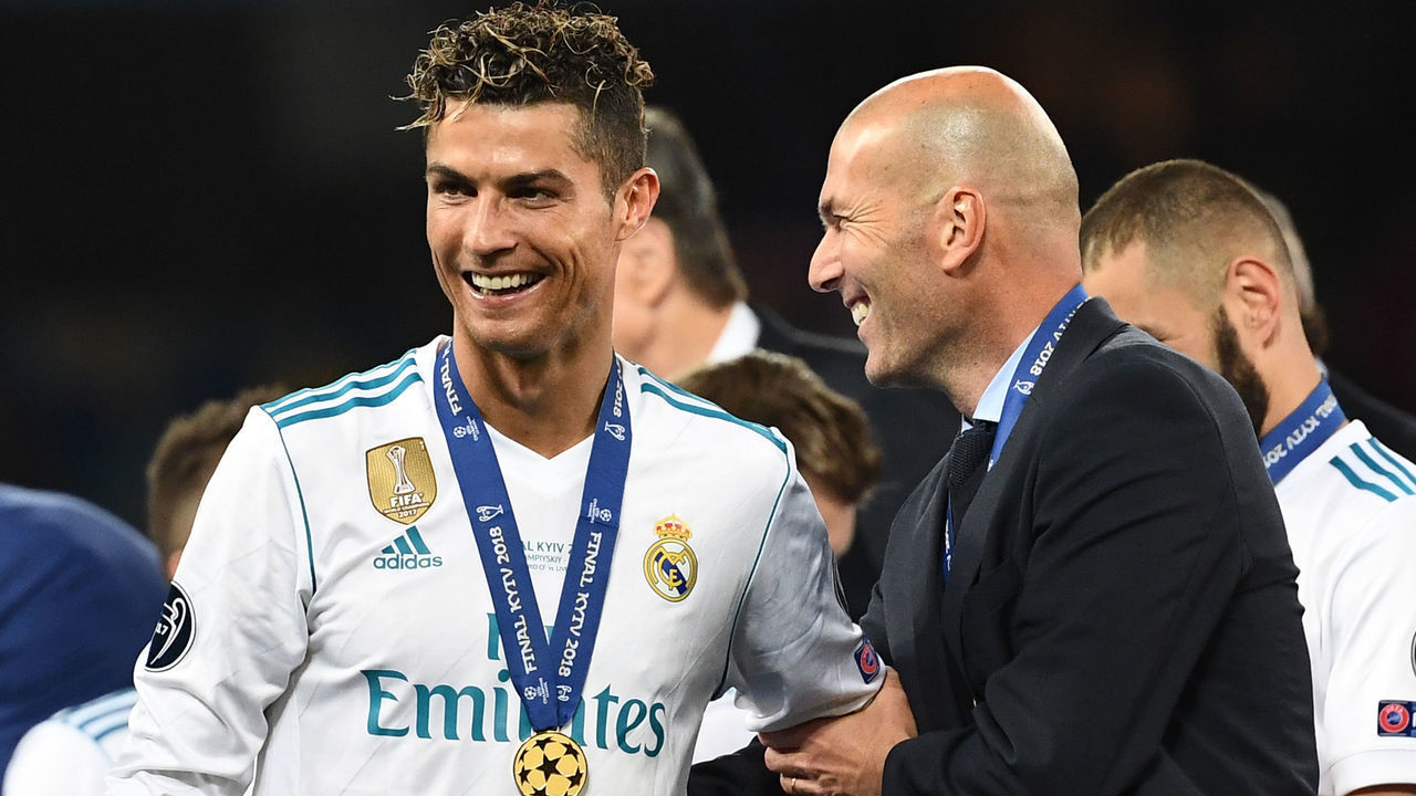 TOPSHOT - Real Madrid's French coach Zinedine Zidane (R) celebrates with Real Madrid's Portuguese forward Cristiano Ronaldo after winning the UEFA Champions League final football match between Liverpool and Real Madrid at the Olympic Stadium in Kiev, Ukraine, on May 26, 2018.