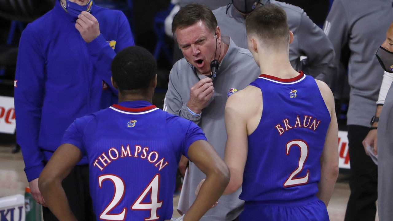 AMES, IA - FEBRUARY 13: Head coach Bill Self of the Kansas Jayhawks coaches Bryce Thompson #24 of the Kansas Jayhawks, and Christian Braun #2 of the Kansas Jayhawks during a time out in the first half of play at Hilton Coliseum on February 13, 2021 in Ames, Iowa. The Kansas Jayhawks won 64-50 over the Iowa State Cyclones.
