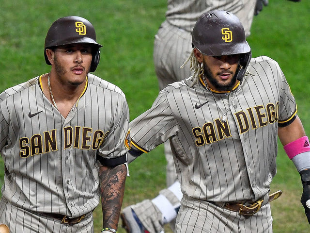 DENVER, CO - AUGUST 31: San Diego Padres third baseman Manny Machado (13) and San Diego Padres shortstop Fernando Tatis Jr. (23) celebrate after a run scored against the Colorado Rockies during a game at Coors Field in Denver, Colorado on August 31, 2020.