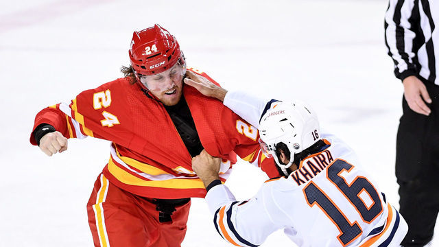 CALGARY, AB - MARCH 15: Calgary Flames Right Wing Brett Ritchie (24) and Edmonton Oilers Center Jujhar Khaira (16) fight during the first period of an NHL game where the Calgary Flames hosted the Edmonton Oilers on March 15, 2021, at the Scotiabank Saddledome in Calgary, AB.