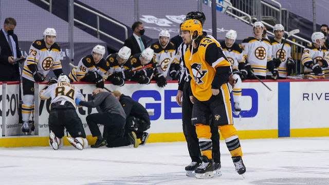 PITTSBURGH, PA - MARCH 16: Pittsburgh Penguins left wing Brandon Tanev (13) skates off the ice after taking a boarding penalty and game misconduct against Boston Bruins defenseman Jarred Tinordi (84) during the second period in the NHL game between the Pittsburgh Penguins and the Boston Bruins on March 16, 2021, at PPG Paints Arena in Pittsburgh, PA.