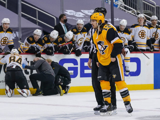 PITTSBURGH, PA - MARCH 16: Pittsburgh Penguins left wing Brandon Tanev (13) skates off the ice after taking a boarding penalty and game misconduct against Boston Bruins defenseman Jarred Tinordi (84) during the second period in the NHL game between the Pittsburgh Penguins and the Boston Bruins on March 16, 2021, at PPG Paints Arena in Pittsburgh, PA.