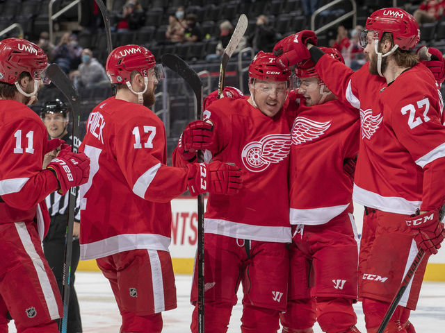 DETROIT, MI - MARCH 16: Filip Zadina #11, Filip Hronek #17, Dylan Larkin #71 and Michael Rasmussen #27 of the Detroit Red Wings congratulate teammate Adam Erne #73 after he scores a goal during the first period of an NHL game against the Carolina Hurricanes at Little Caesars Arena on March 16, 2021 in Detroit, Michigan.