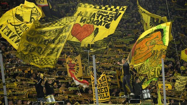 Dortmund's supporters wave scarves and flags during the German first division Bundesliga football match BVB Borussia Dortmund vs Eintracht Frankfurt, in Dortmund, western Germany on February 14, 2020.