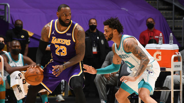 LOS ANGELES, CA - MARCH 18: Miles Bridges #0 of the Charlotte Hornets plays defense on LeBron James #23 of the Los Angeles Lakers during the game on March 18, 2021 at STAPLES Center in Los Angeles, California. NOTE TO USER: User expressly acknowledges and agrees that, by downloading and/or using this Photograph, user is consenting to the terms and conditions of the Getty Images License Agreement. Mandatory Copyright Notice: Copyright 2021 NBAE