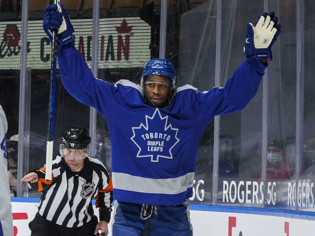 TORONTO, ON - FEBRUARY 6: Wayne Simmonds #24 of the Toronto Maple Leafs celebrates his goal against Braden Holtby #49 of the Vancouver Canucks with teammate Auston Matthews #34 during the first period at the Scotiabank Arena on February 6, 2021 in Toronto, Ontario, Canada.