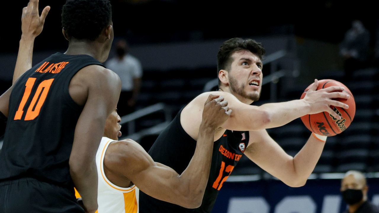 INDIANAPOLIS, INDIANA - MARCH 19: Roman Silva #12 of the Oregon State Beavers drives the ball against Yves Pons #35 of the Tennessee Volunteers during the second half in the first round game of the 2021 NCAA Men's Basketball Tournament at Bankers Life Fieldhouse on March 19, 2021 in Indianapolis, Indiana.