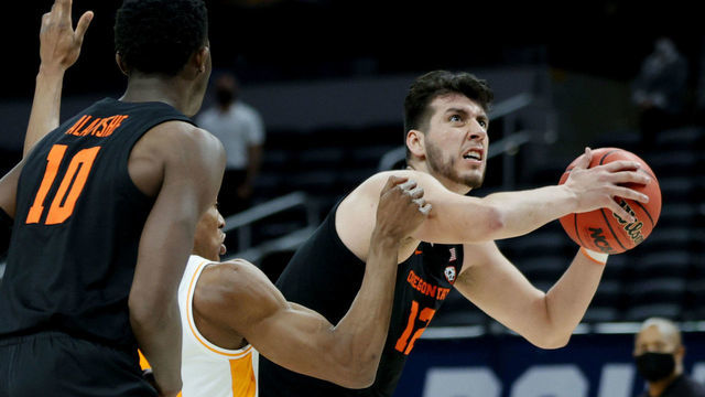 INDIANAPOLIS, INDIANA - MARCH 19: Roman Silva #12 of the Oregon State Beavers drives the ball against Yves Pons #35 of the Tennessee Volunteers during the second half in the first round game of the 2021 NCAA Men's Basketball Tournament at Bankers Life Fieldhouse on March 19, 2021 in Indianapolis, Indiana.