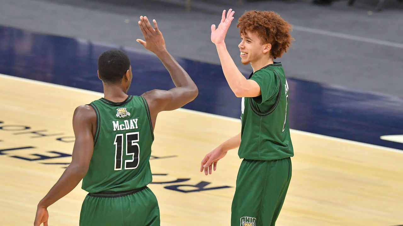 CLEVELAND, OHIO - MARCH 13: Lunden McDay #15 celebrates with Jason Preston #0 of the Ohio Bobcats after Preston scored in the final seconds of the first half of the MAC Men's Championship game against the Buffalo Bulls at Rocket Mortgage Fieldhouse on March 13, 2021 in Cleveland, Ohio.
