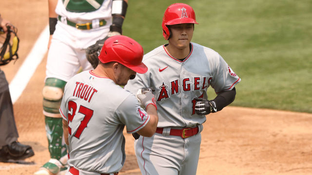 OAKLAND, CALIFORNIA - AUGUST 23: Shohei Ohtani #17 of the Los Angeles Angels is congratulated by Mike Trout #27 after he hit a three-run home run against Frankie Montas #47 of the Oakland Athletics in the third inning at RingCentral Coliseum on August 23, 2020 in Oakland, California.