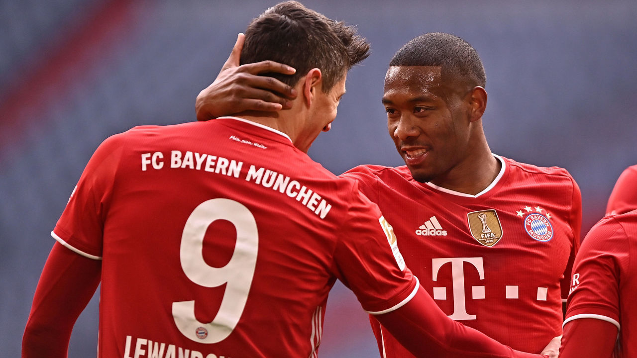 MUNICH, GERMANY - MARCH 20: Robert Lewandowski of FC Bayern Muenchen celebrates with David Alaba after scoring their side's third goal during the Bundesliga match between FC Bayern Muenchen and VfB Stuttgart at Allianz Arena on March 20, 2021 in Munich, Germany. Sporting stadiums around Germany remain under strict restrictions due to the Coronavirus Pandemic as Government social distancing laws prohibit fans inside venues resulting in games being played behind closed doors.
