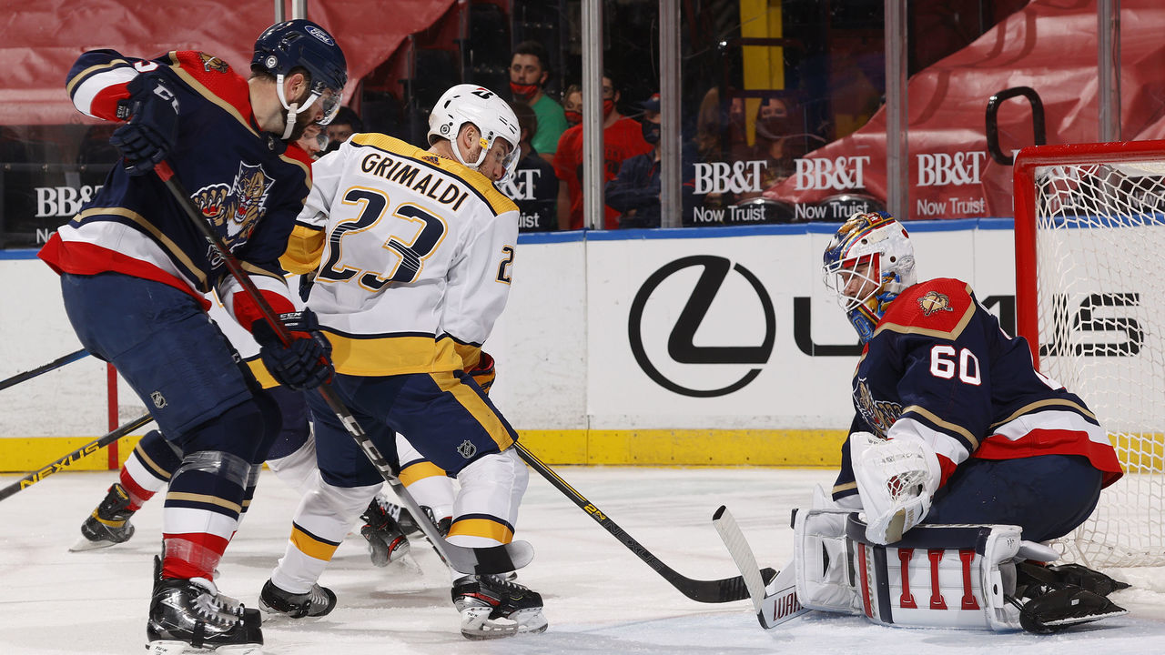 SUNRISE, FL - MARCH 20: Goaltender Chris Driedger #60 of the Florida Panthers stops the shot by Rocco Grimaldi #23 of the Nashville Predators at the BB&T Center on March 20, 2021 in Sunrise, Florida.