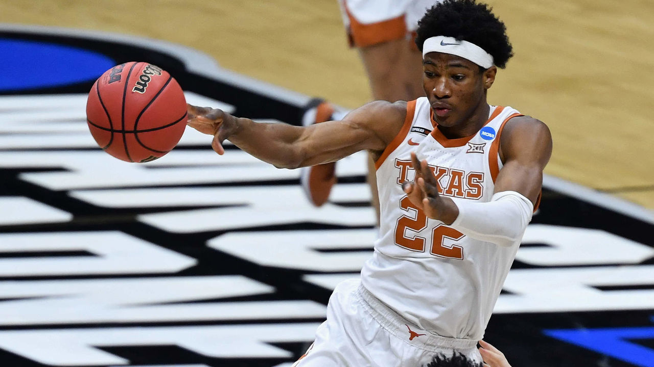 INDIANAPOLIS, IN - MARCH 20: Kai Jones #22 of the Texas Longhorns fouls Coryon Mason #20 of the Abilene Christian Wildcats as he passes off the ball in the first half in the first round of the 2021 NCAA Division I Mens Basketball Tournament held at Lucas Oil Stadium on March 20, 2021 in Indianapolis, Indiana.