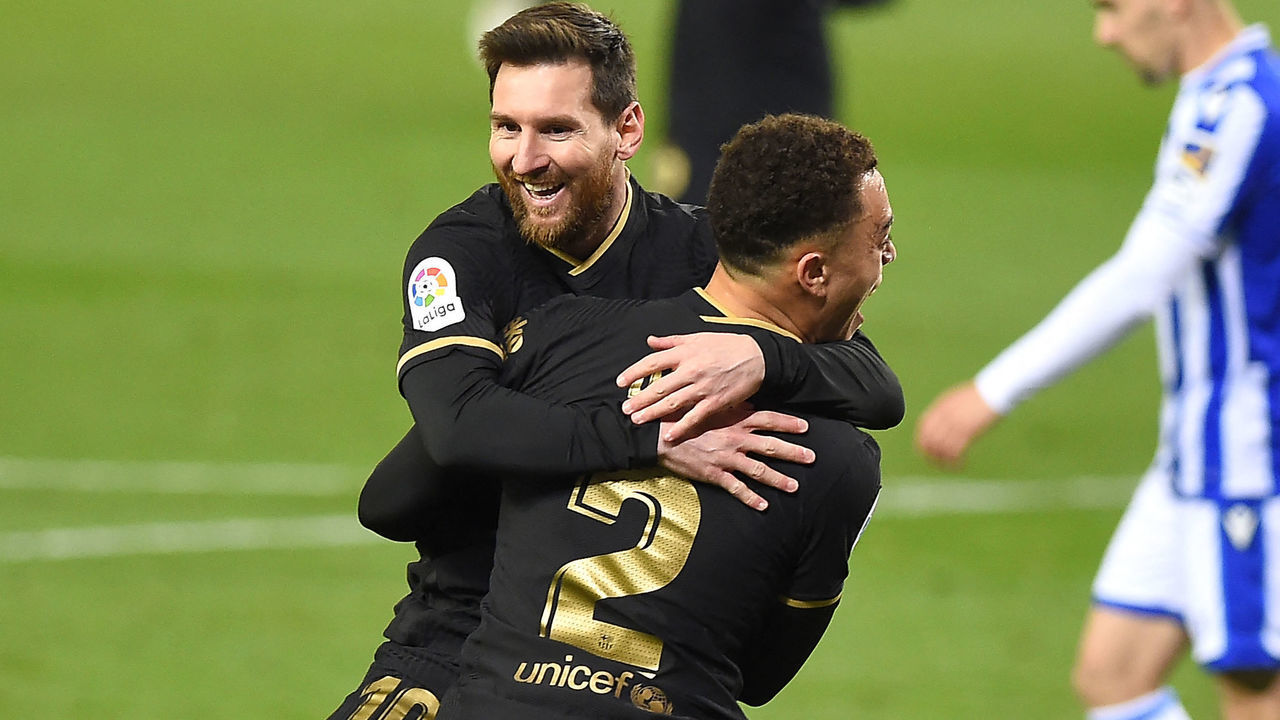 Barcelona's Barcelona's US defender Sergino Dest celebrates with Barcelona's Argentinian forward Lionel Messi (back) after scoring a goal during the Spanish League football match between Real Sociedad and Barcelona at the Anoeta stadium in San Sebastian on March 21, 2021.