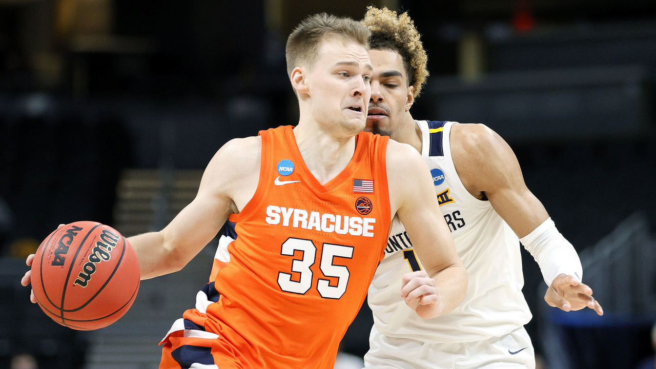 INDIANAPOLIS, INDIANA - MARCH 21: Buddy Boeheim #35 of the Syracuse Orange drives with the ball against Emmitt Matthews Jr. #11 of the West Virginia Mountaineers in the second half of their second round game of the 2021 NCAA Men's Basketball Tournament at Bankers Life Fieldhouse on March 21, 2021 in Indianapolis, Indiana.