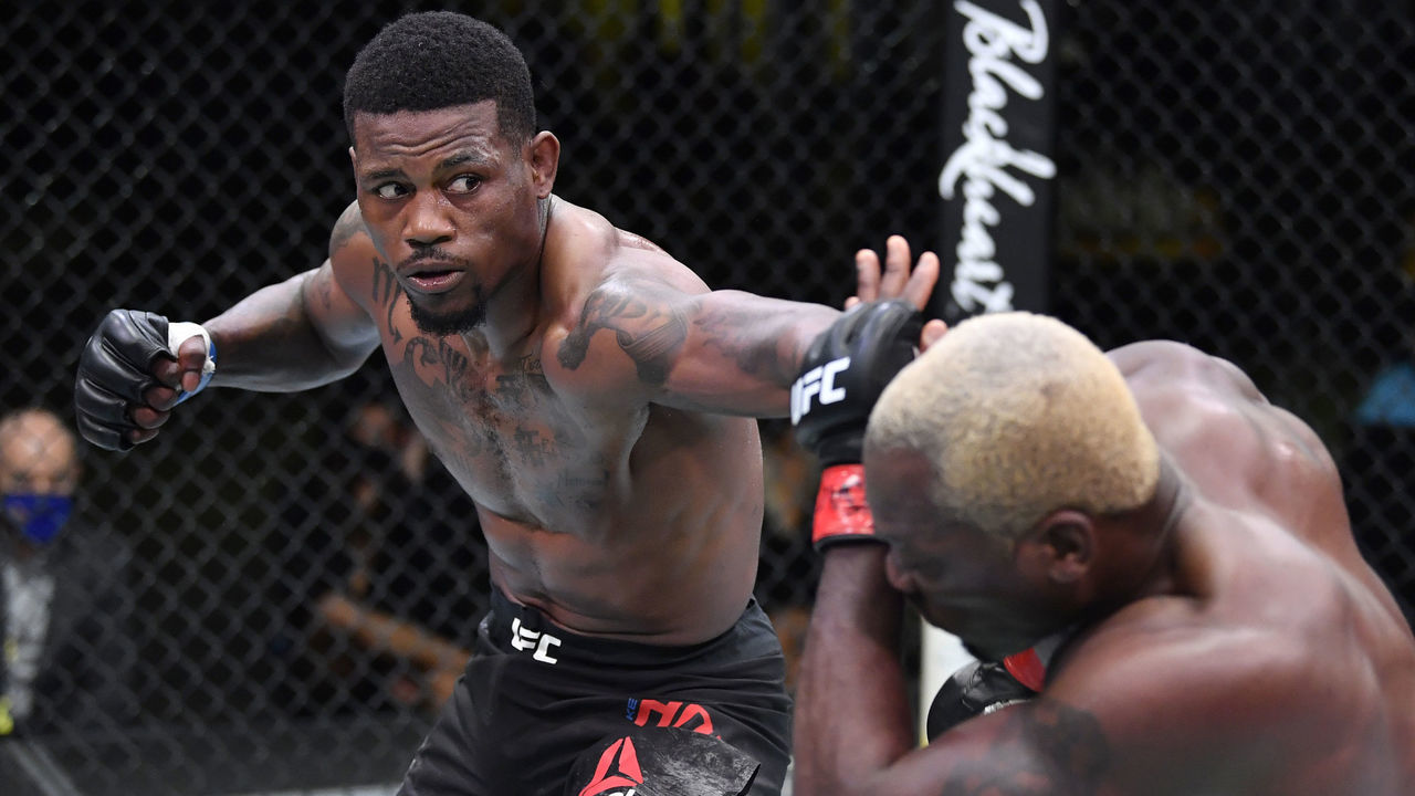 LAS VEGAS, NEVADA - MARCH 20: (L-R) Kevin Holland punches Derek Brunson in their middleweight fight during the UFC Fight Night event at UFC APEX on March 20, 2021 in Las Vegas, Nevada.