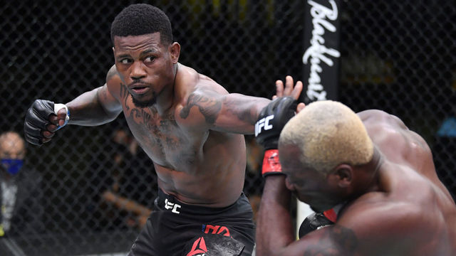 LAS VEGAS, NEVADA - MARCH 20: (L-R) Kevin Holland punches Derek Brunson in their middleweight fight during the UFC Fight Night event at UFC APEX on March 20, 2021 in Las Vegas, Nevada.