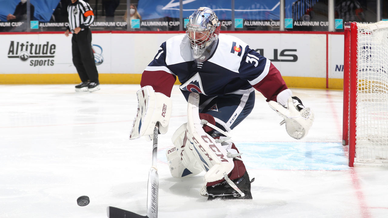 DENVER, COLORADO - MARCH 20: Goaltender Philipp Grubauer #31 of the Colorado Avalanche reaches for a loose puck against the Minnesota Wild at Ball Arena on March 20, 2021 in Denver, Colorado.