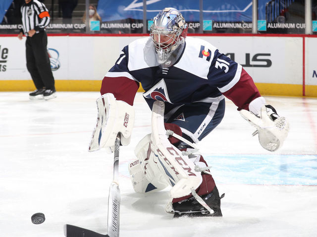 DENVER, COLORADO - MARCH 20: Goaltender Philipp Grubauer #31 of the Colorado Avalanche reaches for a loose puck against the Minnesota Wild at Ball Arena on March 20, 2021 in Denver, Colorado.