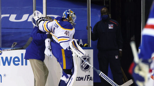 NEW YORK, NEW YORK - MARCH 22: Carter Hutton #40 of the Buffalo Sabres is assisted off the ice following a first period injury against the New York Rangers at Madison Square Garden on March 22, 2021 in New York City.