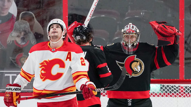OTTAWA, ON - MARCH 22: Making his NHL debut as a starting goaltender, Filip Gustavsson #32 of the Ottawa Senators celebrates his first career NHL win as Sean Monahan #23 of the Calgary Flames looks on at Canadian Tire Centre on March 22, 2021 in Ottawa, Ontario, Canada.