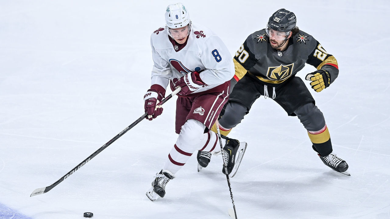 DENVER, CO - FEBRUARY 22: Colorado Avalanche defenseman Cale Makar (8) works near the blue line against Vegas Golden Knights center Chandler Stephenson (20) during a game between the Vegas Golden Knights and the Colorado Avalanche at Ball Arena in Denver, Colorado on February 22, 2021. The Colorado Avalanche wore retro-themed uniforms with logos of the Quebec Nordiques.