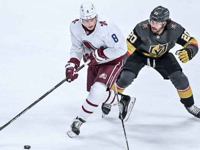 DENVER, CO - FEBRUARY 22: Colorado Avalanche defenseman Cale Makar (8) works near the blue line against Vegas Golden Knights center Chandler Stephenson (20) during a game between the Vegas Golden Knights and the Colorado Avalanche at Ball Arena in Denver, Colorado on February 22, 2021. The Colorado Avalanche wore retro-themed uniforms with logos of the Quebec Nordiques.