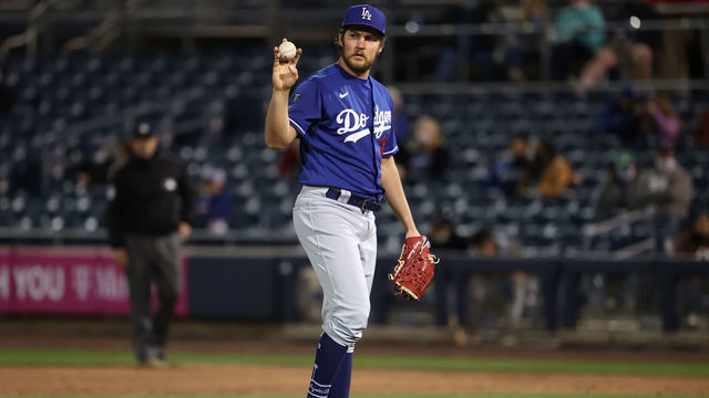 PEORIA, ARIZONA - MARCH 22: Trevor Bauer #27 of the Los Angeles Dodgers reacts in the second inning against the Seattle Mariners during the MLB spring training game at Peoria Sports Complex on March 22, 2021 in Peoria, Arizona.