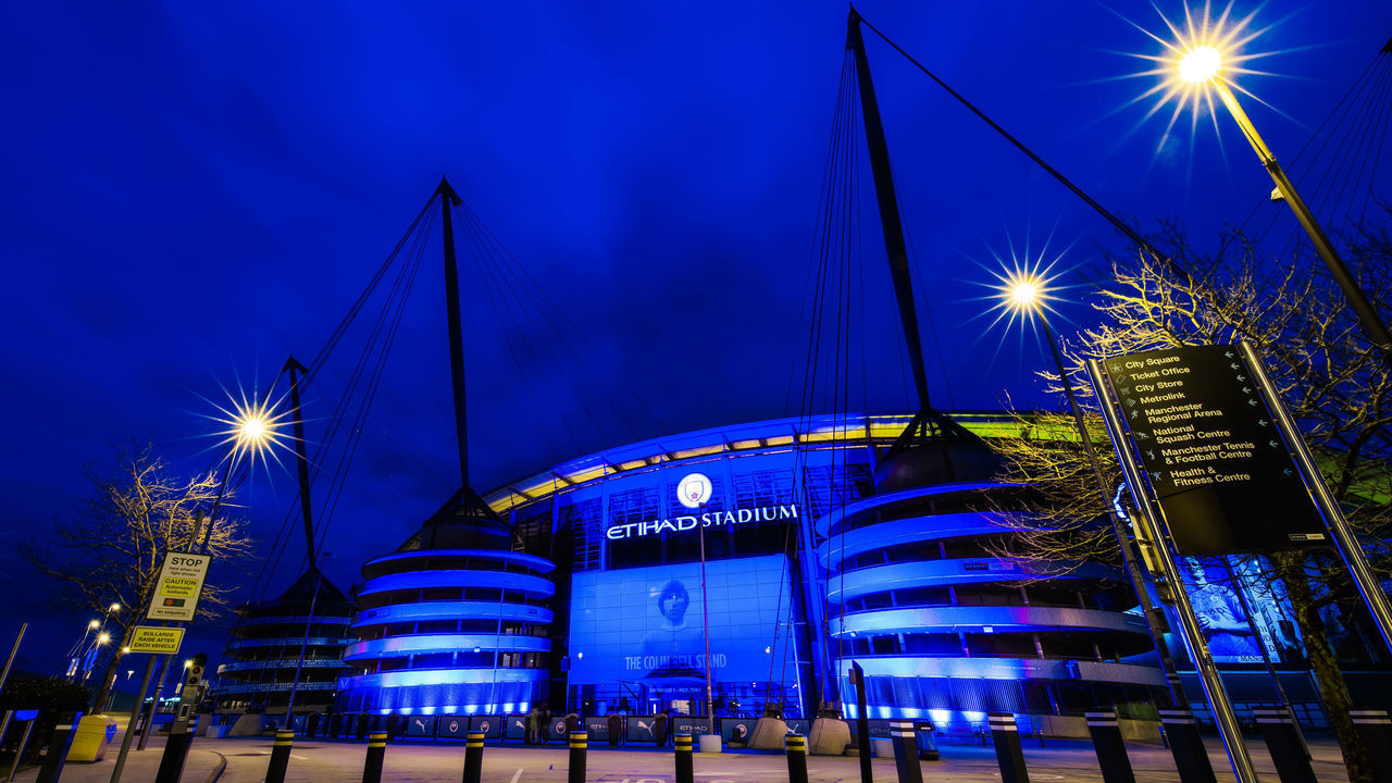 MANCHESTER, ENGLAND - MARCH 23: A general view as the Etihad Stadium is lit up with blue lights as a memorial to mark one year since the first national lockdown due to the coronavirus pandemic at Etihad Stadium on March 23, 2021 in Manchester, England.