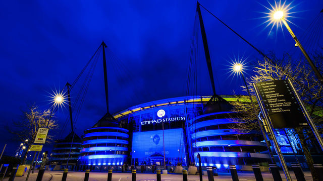 MANCHESTER, ENGLAND - MARCH 23: A general view as the Etihad Stadium is lit up with blue lights as a memorial to mark one year since the first national lockdown due to the coronavirus pandemic at Etihad Stadium on March 23, 2021 in Manchester, England.