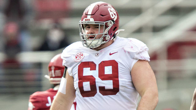 FAYETTEVILLE, AR - DECEMBER 12: Landon Dickerson #69 of the Alabama Crimson Tide at the line of scrimmage during a game against the Arkansas Razorbacks at Razorback Stadium on December 12, 2020 in Fayetteville, Arkansas. The Crimson Tide defeated the Razorbacks 52-3.