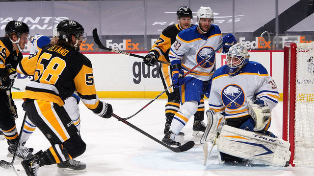 PITTSBURGH, PA - MARCH 24: Kris Letang #58 of the Pittsburgh Penguins scores past Dustin Tokarski #31 of the Buffalo Sabres during the first period at PPG PAINTS Arena on March 24, 2021 in Pittsburgh, Pennsylvania.