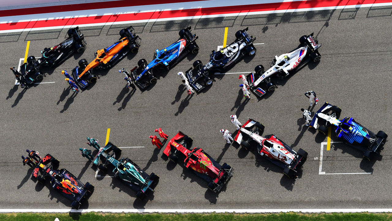 BAHRAIN, BAHRAIN - MARCH 12: (EDITORS NOTE: Image has been digitally retouched) The F1 drivers stand on the grid with their cars during Day One of F1 Testing at Bahrain International Circuit on March 12, 2021 in Bahrain, Bahrain.