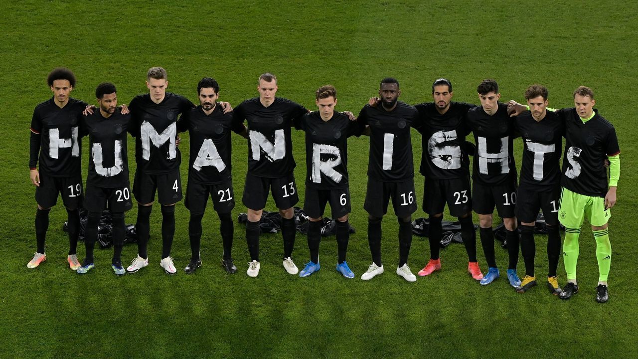 Germany's players pose for a group photo with the wording "Human rights" on their T-shirts prior to the FIFA World Cup Qatar 2022 qualification football match Germany v Iceland in Duisburg, western Germany on March 25, 2021.