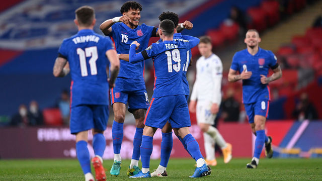 LONDON, ENGLAND - MARCH 25: Ollie Watkins (obscured) of England celebrates with teammates Phil Foden and Tyrone Mings after scoring his team's fifth goal during the FIFA World Cup 2022 Qatar qualifying match between England and San Marino at Wembley Stadium on March 25, 2021 in London, England. Sporting stadiums around the UK remain under strict restrictions due to the Coronavirus Pandemic as Government social distancing laws prohibit fans inside venues resulting in games being played behind closed doors.