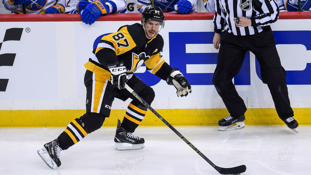 PITTSBURGH, PA - MARCH 25: Pittsburgh Penguins Center Sidney Crosby (87) skates with the puck during the first period in the NHL game between the Pittsburgh Penguins and the Buffalo Sabres on March 25, 2021, at PPG Paints Arena in Pittsburgh, PA.