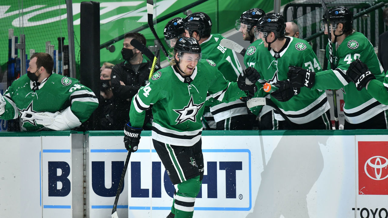 DALLAS, TX - MARCH 25: Roope Hintz #24 of the Dallas Stars gets a water bottle shower from his teammates as he celebrates a goal against the Tampa Bay Lightning at the American Airlines Center on March 25, 2021 in Dallas, Texas.