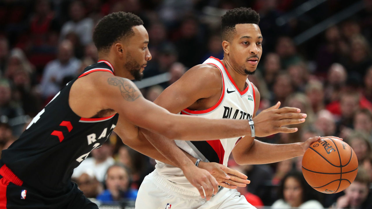 PORTLAND, OREGON - NOVEMBER 13: CJ McCollum #3 of the Portland Trail Blazers dribbles with the ball against Norman Powell #24 of the Toronto Raptors in the second half during their game at Moda Center on November 13, 2019 in Portland, Oregon.