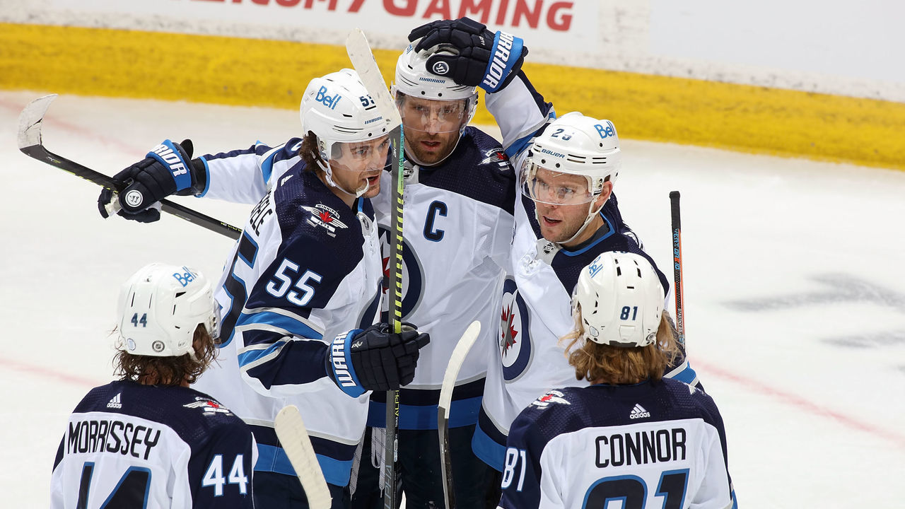 CALGARY, AB - MARCH 26: The Winnipeg Jets celebrate on ice after a goal against the Calgary Flames at Scotiabank Saddledome on March 26, 2021 in Calgary, Alberta, Canada.