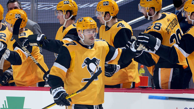 PITTSBURGH, PA - MARCH 27: Bryan Rust #17 of the Pittsburgh Penguins celebrates his second goal in the second period against the New York Islanders at PPG PAINTS Arena on March 27, 2021 in Pittsburgh, Pennsylvania.