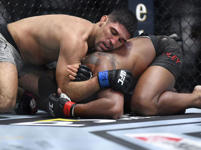 LAS VEGAS, NEVADA - MARCH 27: (L-R) Vicente Luque secures a submission against Tyron Woodley in their welterweight fight during the UFC 260 event at UFC APEX on March 27, 2021 in Las Vegas, Nevada.