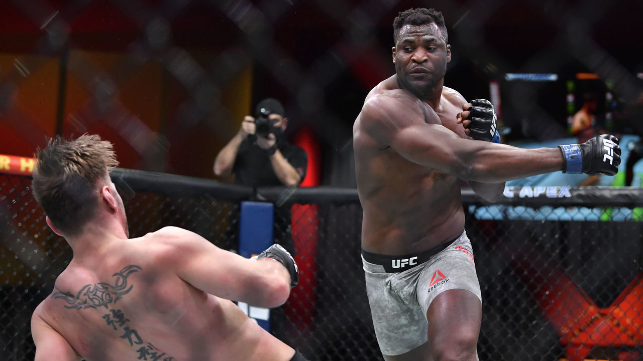 LAS VEGAS, NEVADA - MARCH 27: (R-L) Francis Ngannou of Cameroon drops Stipe Miocic in their UFC heavyweight championship fight during the UFC 260 event at UFC APEX on March 27, 2021 in Las Vegas, Nevada.