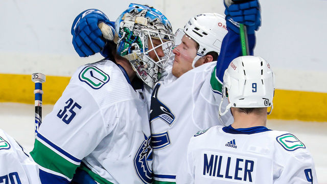 WINNIPEG, MB - MARCH 1: Goaltender Thatcher Demko #35 of the Vancouver Canucks celebrates with teammates Brock Boeser #6 and J.T. Miller #9 following a 4-0 shutout victory over the Winnipeg Jets at the Bell MTS Place on March 1, 2021 in Winnipeg, Manitoba, Canada.