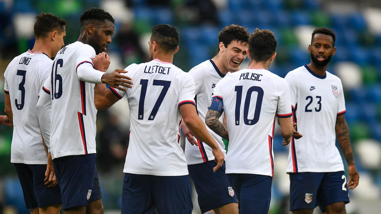 Northern Ireland , United Kingdom - 28 March 2021; Christian Pulii, 10, of USA is congratulated by teammates, including Giovanni Reyna, after scoring his side's second goal from a penalty during the International friendly match between Northern Ireland and USA at the National Football Stadium at Windsor Park in Belfast.