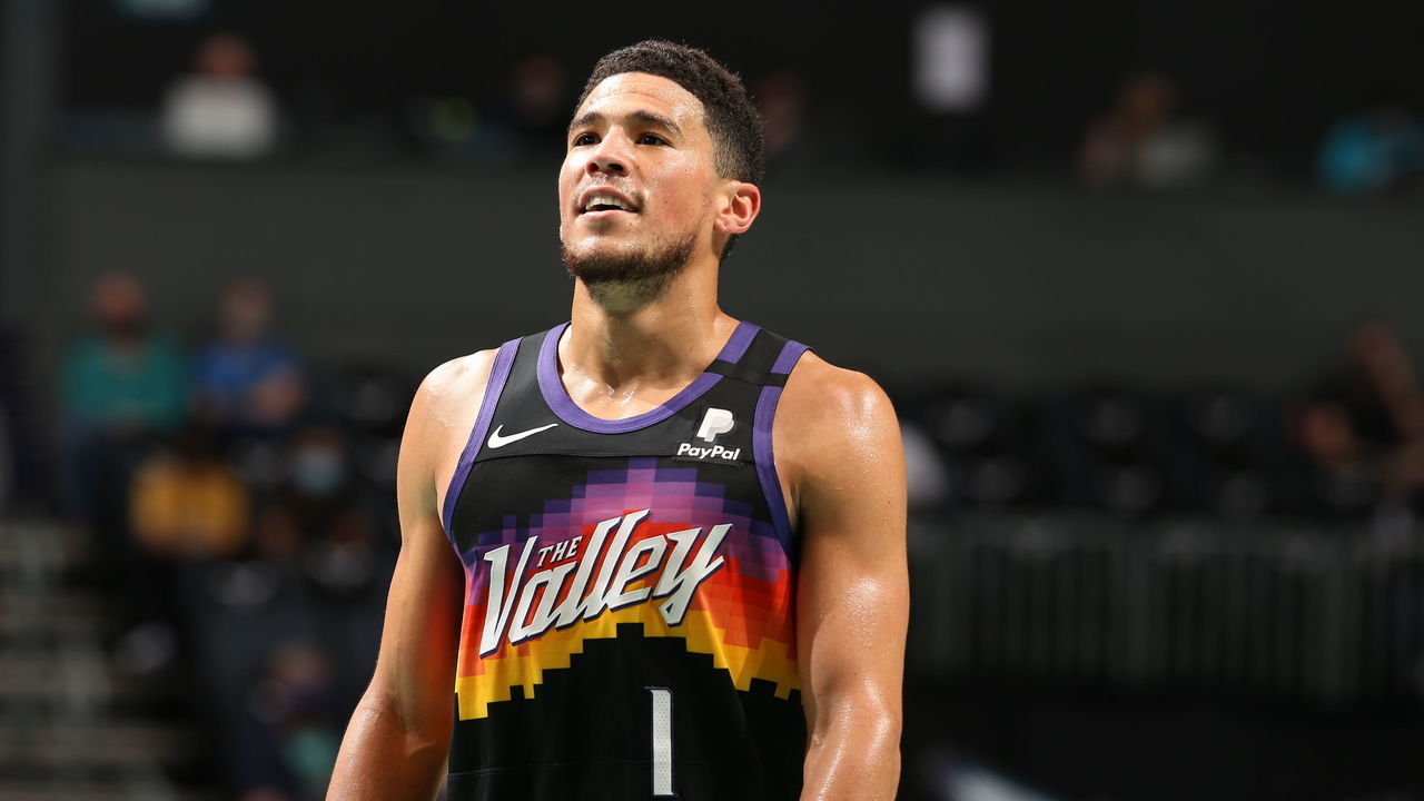 CHARLOTTE, NC - MARCH 28: Devin Booker #1 of the Phoenix Suns looks on during the game against the Charlotte Hornets on March 28, 2021 at Spectrum Center in Charlotte, North Carolina. Mandatory Copyright Notice: Copyright 2021 NBAE
