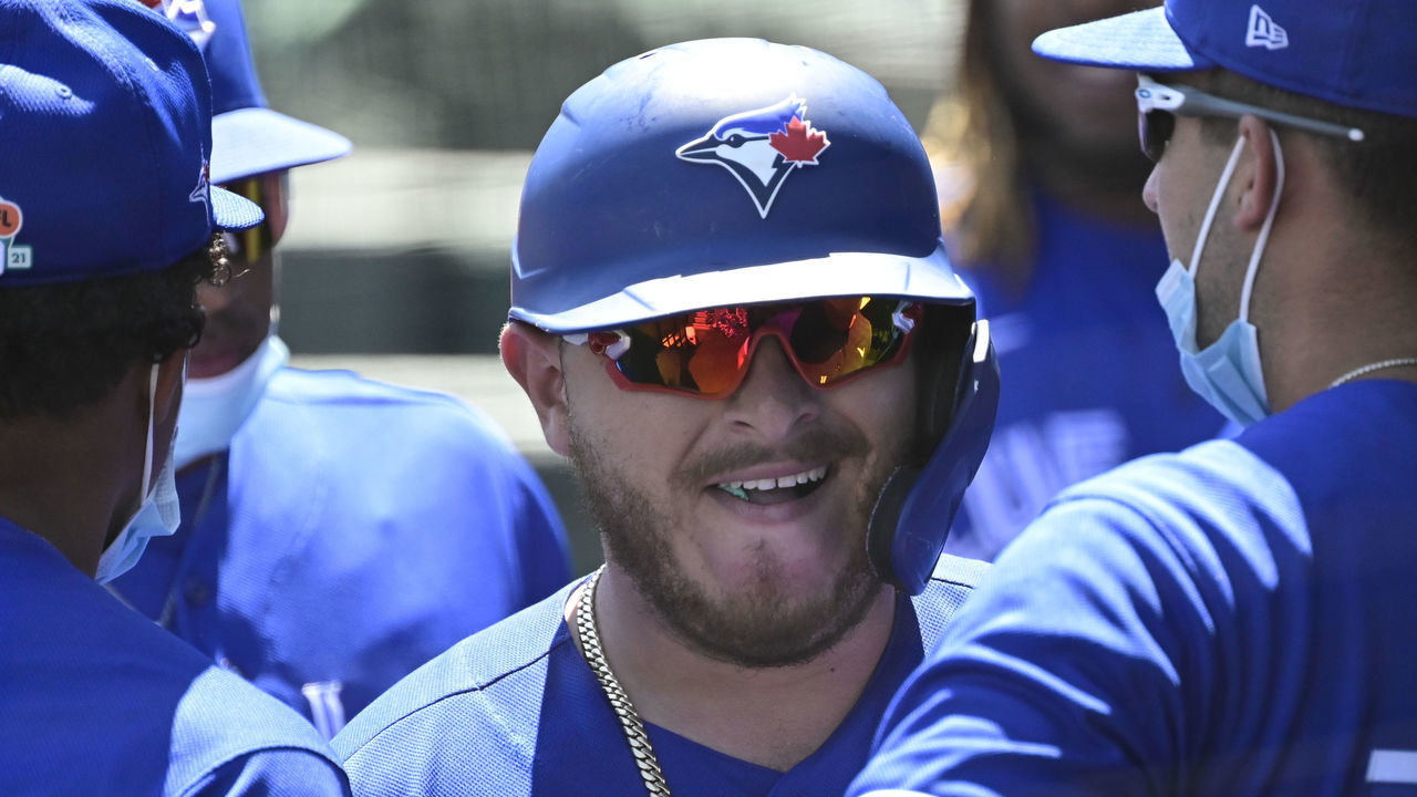 LAKELAND, FLORIDA - MARCH 19: Alejandro Kirk #30 of the Toronto Blue Jays celebrates with his teammates in the dugout after hitting a solo home run during the second inning against the Detroit Tigers during a spring training game at Publix Field at Joker Marchant Stadium on March 19, 2021 in Lakeland, Florida.