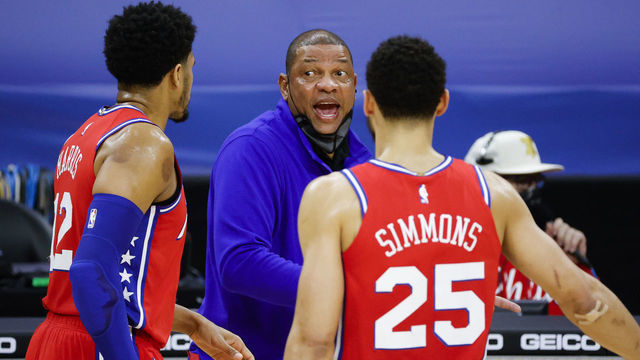 PHILADELPHIA, PENNSYLVANIA - MARCH 03: Head coach Doc Rivers of the Philadelphia 76ers speaks with Tobias Harris #12 and Ben Simmons #25 during the second quarter against the Utah Jazz at Wells Fargo Center on March 03, 2021 in Philadelphia, Pennsylvania.