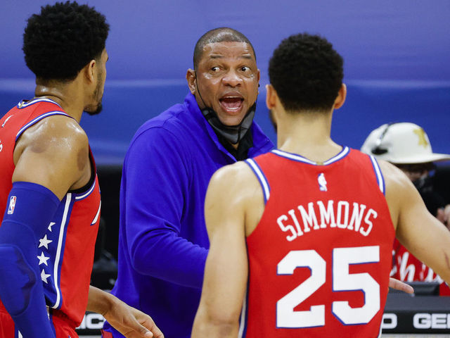 PHILADELPHIA, PENNSYLVANIA - MARCH 03: Head coach Doc Rivers of the Philadelphia 76ers speaks with Tobias Harris #12 and Ben Simmons #25 during the second quarter against the Utah Jazz at Wells Fargo Center on March 03, 2021 in Philadelphia, Pennsylvania.
