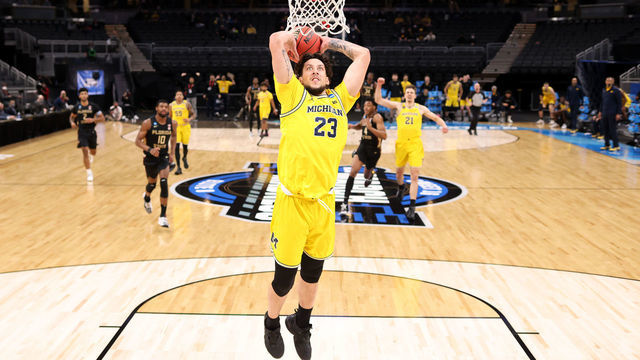 INDIANAPOLIS, INDIANA - MARCH 28: Brandon Johns Jr. #23 of the Michigan Wolverines dunks the ball against the Florida State Seminoles in the first half of their Sweet Sixteen round game of the 2021 NCAA Men's Basketball Tournament at Bankers Life Fieldhouse on March 28, 2021 in Indianapolis, Indiana.