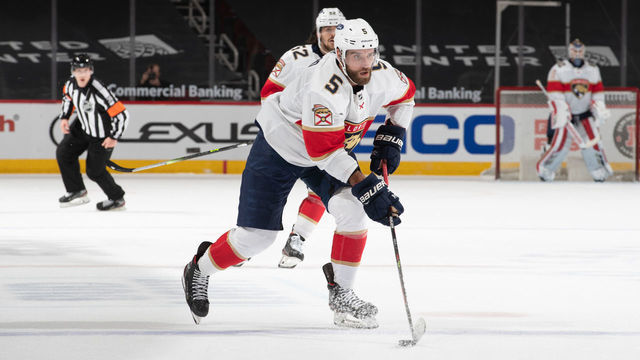 CHICAGO, IL - MARCH 23: Aaron Ekblad (5) of the Florida Panthers carries the puck into the offensive zone at the United Center on March 23, 2021 in Chicago, Illinois.